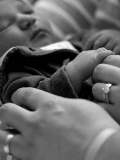 LINCOLN, NEB. - 01/01/2018 - Jenna and Brad Myers hold hands with their daughter Brianna on Monday, Jan. 1, 2018, at Bryan East. Brianna Myers was the first baby born in Lincoln in 2018 arriving at 12:14 a.m. KAYLA WOLF, Journal Star