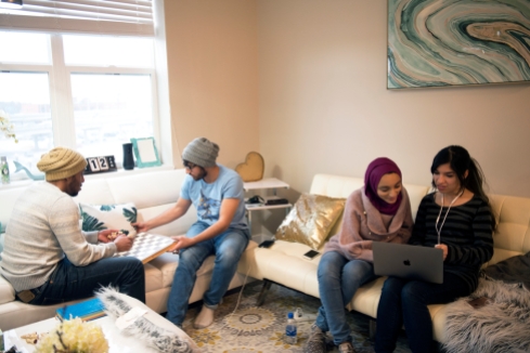 LINCOLN, NEB. - 01/12/2018 - Omani students (from left) Asim Al-Dhdahri, Ahmed Al Afifi, Fatma Al-Sharji and Dania Al Ghailani hangout Friday, Jan. 12, 2018 at a friends apartment in downtown Lincoln. After China and India, the third largest population of students at the University of Nebraska is from the Middle Eastern country of Oman. KAYLA WOLF, Journal Star
